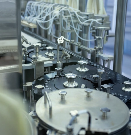 A  group of people in lab coats looking at a machine